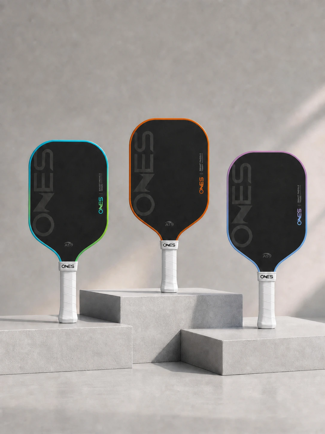 Three ONES A1 paddle colorways displayed on sculpted plinths